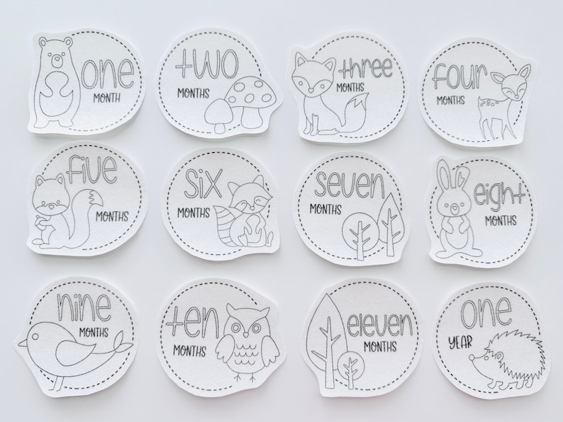 May include: Black and white printable baby milestone cards featuring woodland animals and the numbers one through twelve. The cards are designed to be used for monthly baby photos.