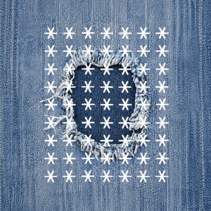 May include: Close-up of denim fabric with a distressed patch. The patch is a square shape with frayed edges, and is filled with white star shapes. The surrounding denim is a medium blue color.