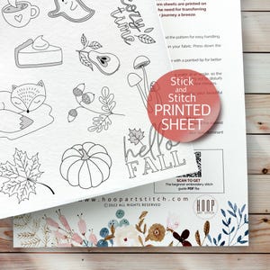 May include: A black and white printable embroidery pattern sheet with a variety of fall-themed designs, including a pumpkin, a fox, a mushroom, a leaf, and a pie. The sheet also includes the text "hello fall" and a QR code to scan for a beginner embroidery stitch guide PDF file. The sheet is from the website hoop artstitch.com.