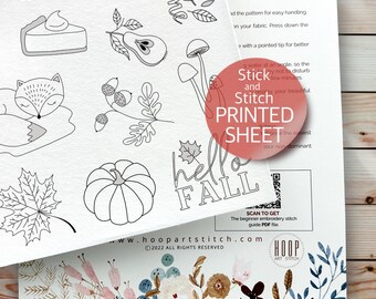May include: A black and white printable embroidery pattern sheet with a variety of fall-themed designs, including a pumpkin, a fox, a mushroom, a leaf, and a pie. The sheet also includes the text "hello fall" and a QR code to scan for a beginner embroidery stitch guide PDF file. The sheet is from the website hoop artstitch.com.