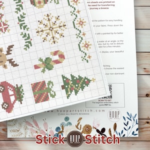 May include: A cross-stitch pattern sheet featuring holiday motifs like snowflakes, candy canes, gift boxes, and Christmas trees on a grid. The document includes text instructions, a QR code for a guide, and the Hoop Art Stitch logo at the bottom.