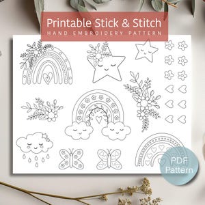 May include: Printable stick and stitch embroidery pattern featuring rainbows, clouds, stars, butterflies, flowers, and hearts. The pattern is black and white and includes the text "PDF Pattern".