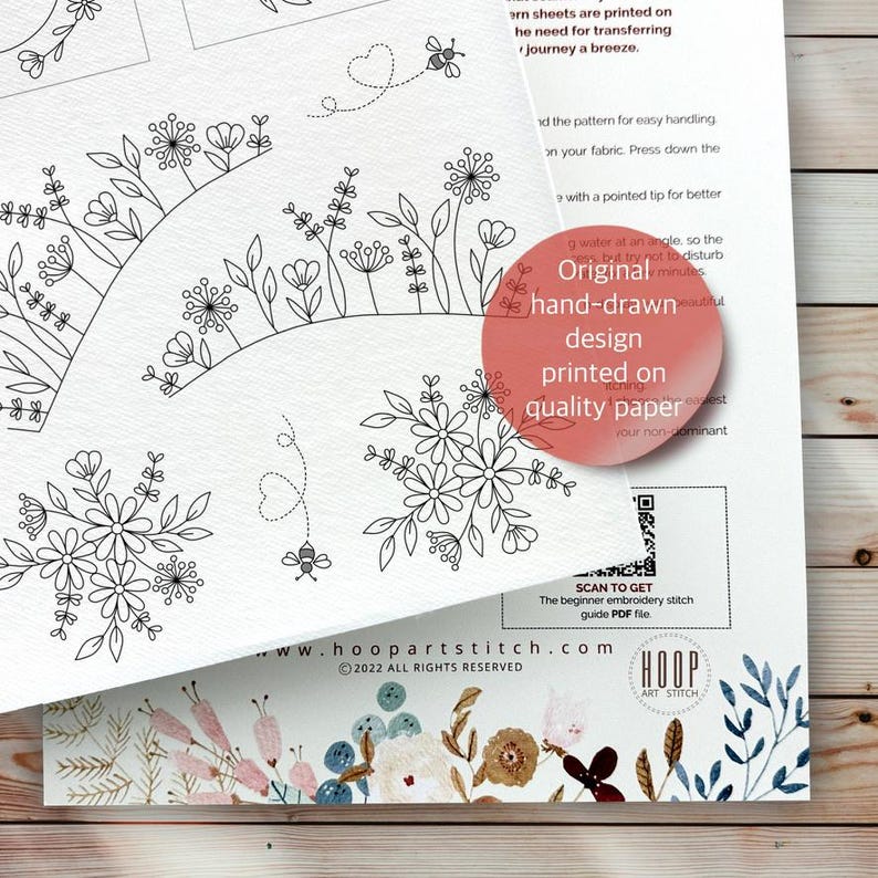 Puede incluir: Una hoja de papel blanco con patrones de bordado en l&iacute;nea negra de flores silvestres, abejas y trayectorias de vuelo en forma de coraz&oacute;n. Un c&iacute;rculo rojo contiene el texto Original hand-drawn design printed on quality paper. Incluye un c&oacute;digo QR.