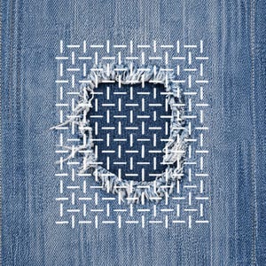 May include: Close-up of blue denim fabric with a square patch. The patch is stitched with white thread in a grid pattern, covering a distressed area. The edges of the patch are frayed, adding texture to the design.