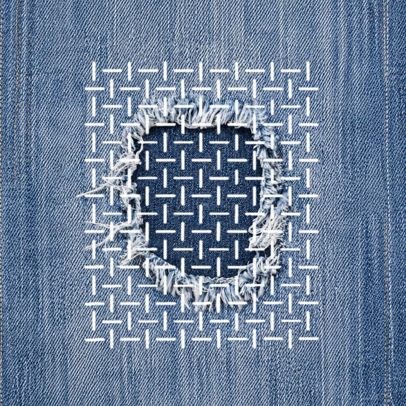 May include: Close-up of blue denim fabric with a square patch. The patch is stitched with white thread in a grid pattern, covering a distressed area. The edges of the patch are frayed, adding texture to the design.