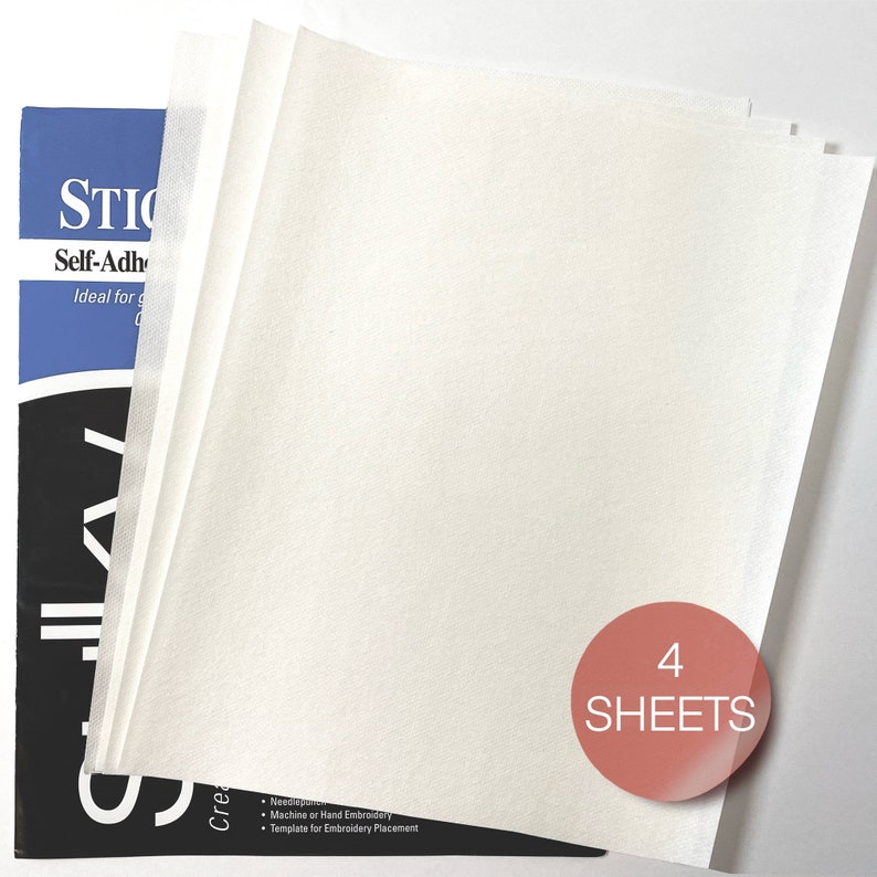 May include: Four sheets of white self-adhesive stabilizer paper. The paper is ideal for machine or hand embroidery and templates for embroidery placement. The package has the text "4 SHEETS" on a red circle.