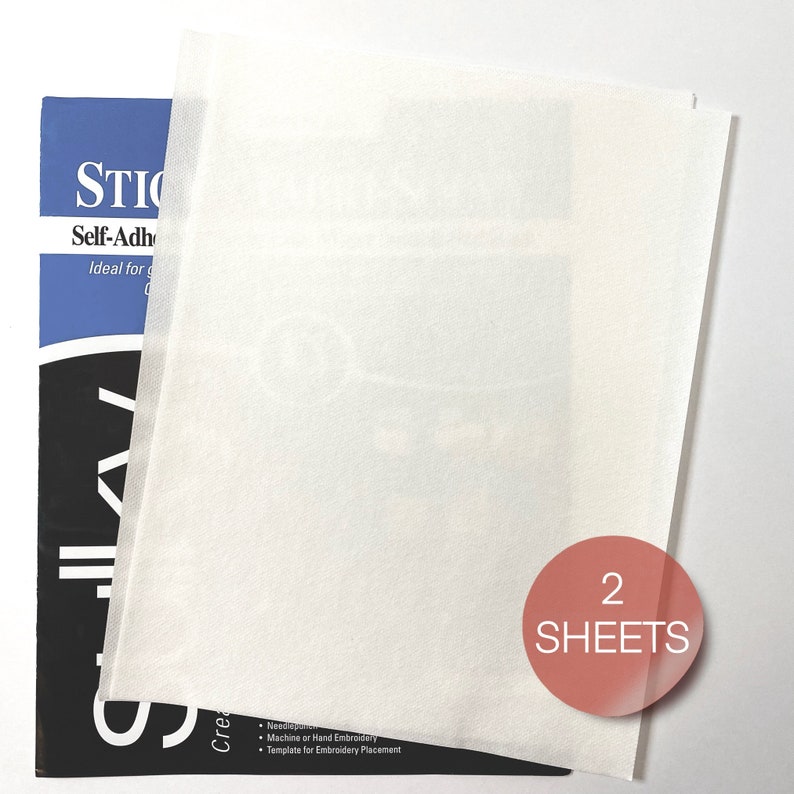 May include: Two sheets of white self-adhesive stabilizer paper. The paper is ideal for machine or hand embroidery and can be used as a template for embroidery placement. The package says "STIC Self-Adhesive".