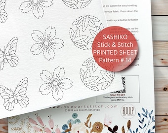May include: A white printed sheet with black Sashiko embroidery patterns of flowers, butterflies, and leaves. The sheet includes the text "SASHIKO Stick & Stitch PRINTED SHEET Pattern #14" and a QR code for a beginner's guide.