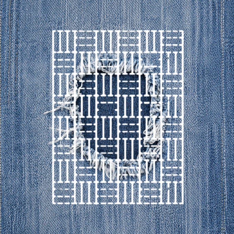 May include: Close-up of a denim fabric with a distressed patch. The patch is a square with a white geometric design overlaying the frayed edges of the denim. The background is a medium blue denim.