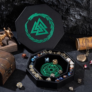 May include: Black octagonal dice tray with a green Celtic knot design and a matching lid. The lid features a green serpent encircling a symbol. Various polyhedral dice are inside the tray.