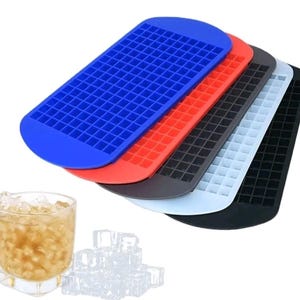 May include: A stack of five rectangular silicone ice cube trays in blue, red, dark grey, light blue, and black, each featuring a grid of small square compartments. A clear glass filled with amber liquid and small ice cubes sits nearby.