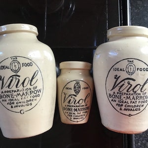 May include: Three cream-coloured ceramic jars of different sizes. Each jar has a black label with the text "Virol" and "A preparation of bone-marrow, an ideal fat food for children & invalids."