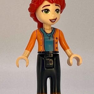 Mia wearing lime cropped trousers and a striped top LEGO® Friends Minifigure.