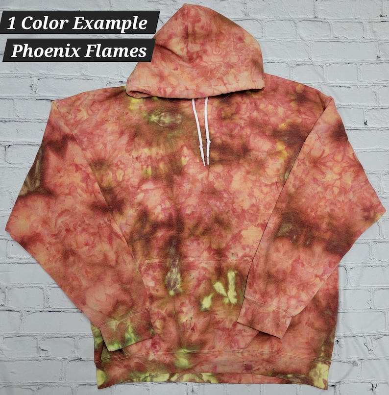 May include: A red, orange and yellow tie-dye hoodie with a white drawstring. The hoodie has a "1 Color Example Phoenix Flames" text label.