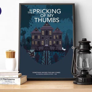 May include: Framed poster with the text "BY THE PRICKING OF MY THUMBS" and "SOMETHING WICKED THIS WAY COMES". The artwork features a dark blue background with a spooky house illustration. A black lantern sits to the right.