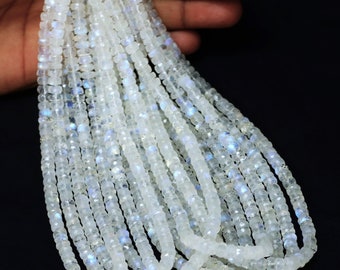 May include: A strand of white moonstone beads, faceted and polished, with a subtle iridescent sheen. The beads are strung on a clear thread and are approximately 4mm in size.