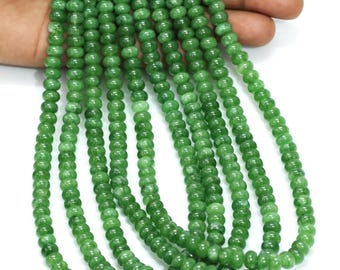 May include: Several strands of green gemstone beads. The beads are small, round, and polished. The vibrant green beads are strung together. The image displays multiple strands of beads, likely for jewellery making or crafting.