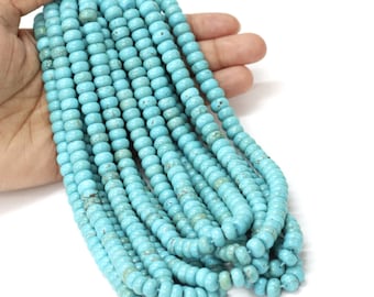May include: A strand of turquoise beads, approximately 15 inches long, with a light blue color and a smooth, round shape.