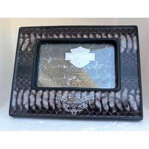 May include: A rectangular Harley-Davidson photo frame with a black and grey snakeskin pattern. The frame features a black border and a central graphic with the Harley-Davidson Motor Cycles shield logo and tribal accents. It holds a 4 x 6 inch photo.