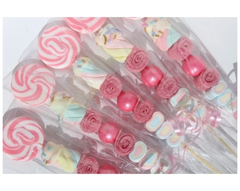 May include: A set of pink and white candy skewers with lollipops, marshmallows, and gummy candies. The skewers are wrapped in clear cellophane and tied with pink ribbon.
