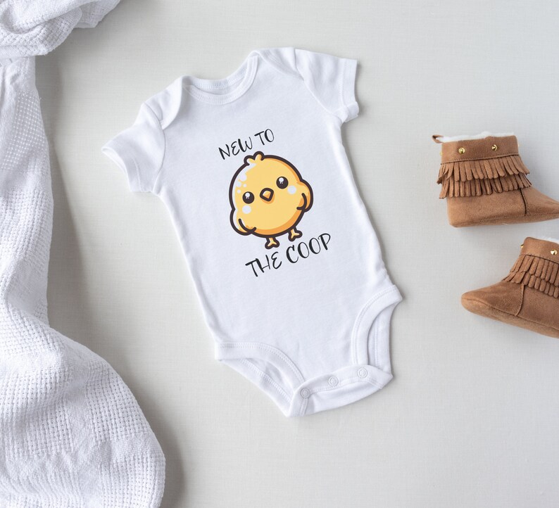 May include: White baby onesie with a yellow chick cartoon and the text "New to the coop".