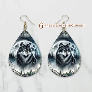 May include: A pair of silver teardrop-shaped earrings with a wolf howling at the moon design. The earrings feature a black and white wolf with a blue moon and a forest background.