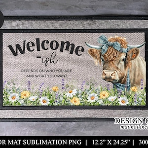 May include: Rectangular doormat with a cow illustration wearing a blue bow and bandana. The mat features the text "Welcome-ish" and a floral border. Dimensions are 12.2" x 24.25".