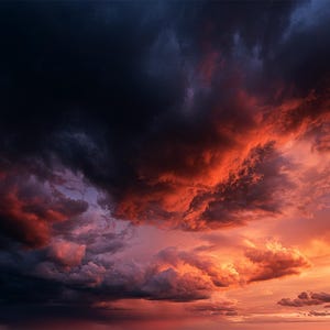 May include: A dramatic sky filled with dense, dark storm clouds transitioning into vibrant shades of orange, red, and deep purple. The heavy, textured cloud formations create a stark contrast between the shadowed areas and the bright sunset light.