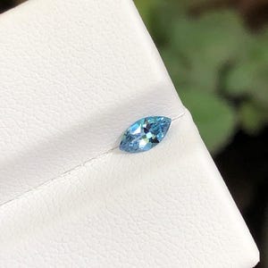 May include: A set of three ceramic mugs with a speckled, matte finish. The mugs are in shades of cream, light gray, and dark gray. Each mug has a simple, minimalist design, perfect for coffee or tea.