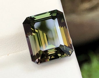 Natural Unheated Tanzanite, 7.48 Ct weight, Bronzey Green Colour ( so uniqe ) Size is near to 12.04 × 10.08 × 7.04 MM ( Read discription )
