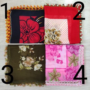 May include: Four different square scarves with floral patterns and crocheted borders. The scarves are in black, red, green, and pink.