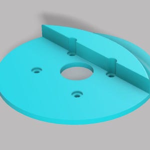 May include: A turquoise 3D-printed object with a circular base and a curved, rectangular top section. The base has a central hole and three smaller holes. The top section has two slots. The object is designed for a specific purpose.