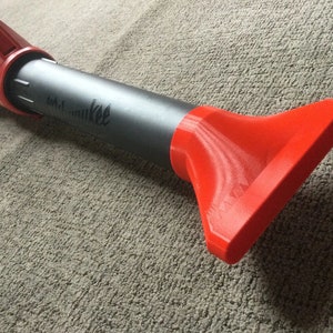 May include: A gray and red leaf blower with the word "Milwaukee" printed on the side. The blower has a red nozzle.