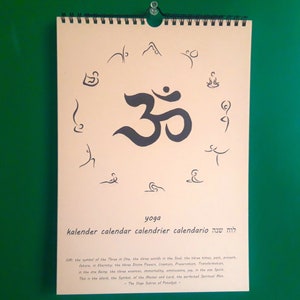 May include: A beige calendar with a black Om symbol surrounded by yoga poses. The calendar is titled "yoga kalender calendar calendrier calendario  מה שיה  ". The text below the title reads "Om the symbol of the Three One, the three worlds in the three times past, present, future, in Eternity, the Three Divine Powers, Creation, Preservation, Transmutation, or the Three Sounds, Aum, the sound of the Mother and the Lord, the perfect spiritual man. This is the blend, the symbol of the eternally and endlessly articulated Spiritual Sun. - The Yoga Sutra of Patanjali -"