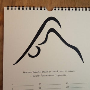 May include: A black and white illustration of a yoga pose on a beige calendar page. The quote "Humans become angels on earth, not in heaven. - Swami Paramahansa Yogananda -" is printed below the illustration.