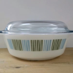 May include: White casserole dish with a glass lid. The dish has a blue, green and brown striped pattern.