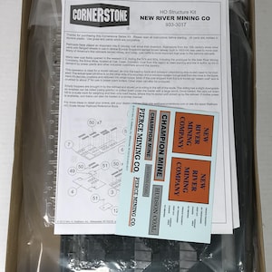 May include: A model railroad kit for a coal mining operation. The kit includes a tipple, conveyor system, and decals for the New River Mining Company, Champion Mine, and Hudson Coal. The kit is made by Cornerstone Series.