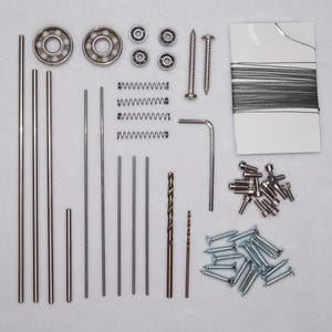May include: An assortment of hardware components, including ball bearings, springs, screws, and metal rods, arranged on a white surface. The image showcases various sizes and shapes of metal fasteners and mechanical parts, ideal for DIY projects or repairs.