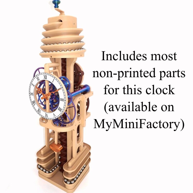May include: A vertical mechanical marble clock with a beige frame, blue and brown internal gears, and a white clock face featuring black Roman numerals. The text reads: Includes most non-printed parts for this clock (available on MyMiniFactory).