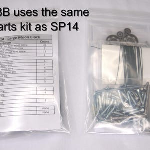 May include: A parts list for a large moon clock kit, with a description of each part and the quantity included. The parts are organized in a table with the part name and count. The parts include screws, dowel pins, music wire, drill bits, a pen spring, bearings, and fishing line.