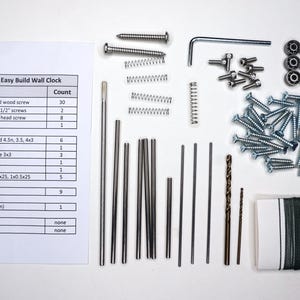 May include: A parts kit for building a wall clock. The kit includes screws, dowel pins, drill bits, springs, a hex key, a bearing, and fishing line. The kit also includes a list of parts and their quantities.