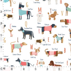 May include: A white fabric with colourful illustrations of dog breeds, each wearing sweaters and labelled with letters. Breeds include a Great Dane, Maltese, and Toy Poodle. A centimetre ruler is shown on the left side.