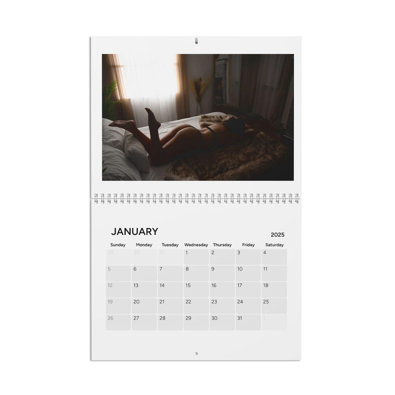 May include: A calendar for January 2025 with a photo of a person lying on a bed. The photo is in black and white.
