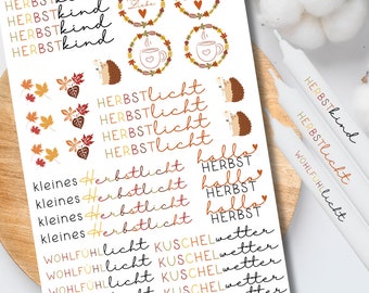 May include: A sticker sheet featuring autumn-themed designs including text like Herbstkind, Herbstliebe, Herbstlicht, and Kuschelwetter, alongside illustrations of hedgehogs, fall leaves, and mugs. The stickers are printed in orange, brown, and black ink.