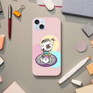 May include: A pink phone case with a white teapot and saucer design. The teapot is decorated with flowers and a butterfly. The saucer is decorated with lace.