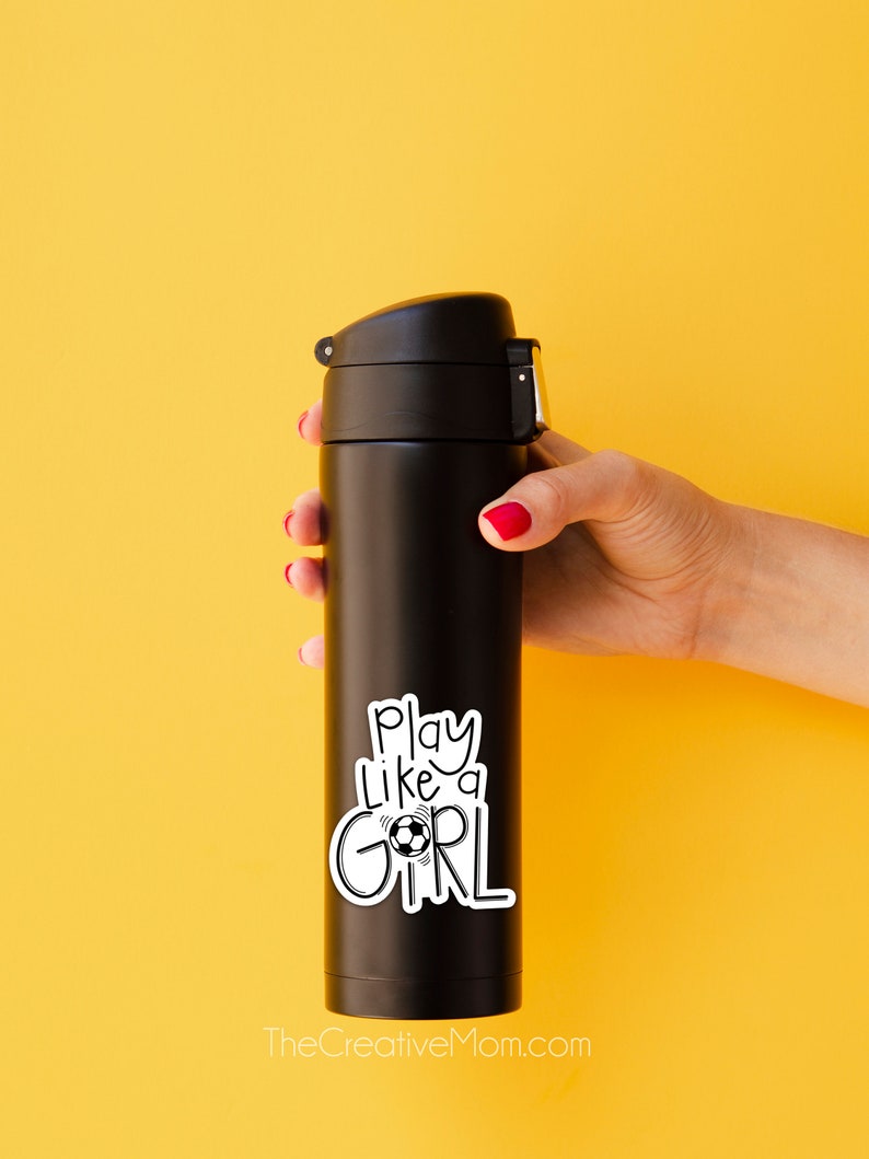 May include: Black insulated water bottle with a white sticker that says "Play like a girl" with a soccer ball graphic.