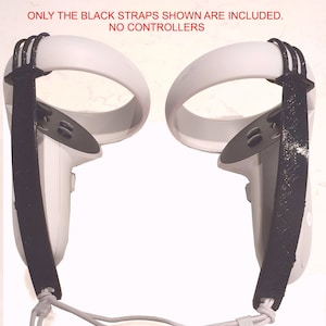 May include: A pair of white VR headset straps with black adjustable straps. The text "ONLY THE BLACK STRAPS SHOWN ARE INCLUDED. NO CONTROLLERS" is printed above the straps.