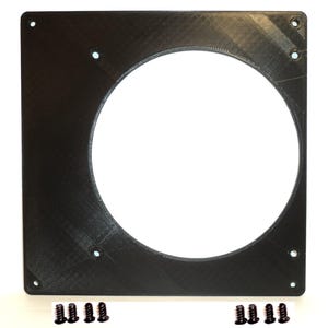 May include: A black square fan mount with a large circular opening in the center. The mount has several small holes for screws, and a set of black screws are included. The mount is made of a textured plastic material.
