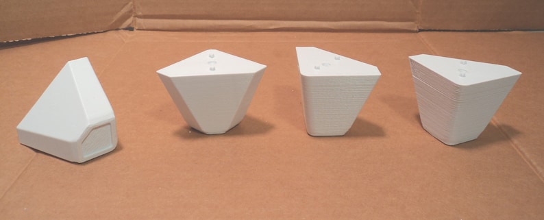 Puede incluir: Cuatro soportes de esquina de pl&aacute;stico blanco, cada uno con tres agujeros, dise&ntilde;ados para sostener las patas de los muebles.