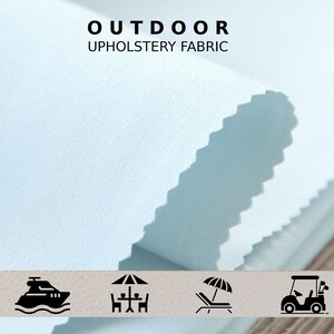May include: A close-up of a light blue outdoor upholstery fabric. The fabric is shown folded and has a subtle texture. The image includes icons for a boat, a table with chairs, a lounge chair with an umbrella, and a golf cart.
